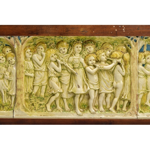 268 - A DELLA ROBBIA THREE SECTION RECTANGULAR PLAQUE MOULDED IN RELIEF WITH A PROCESSION OF CHILDREN THRO... 