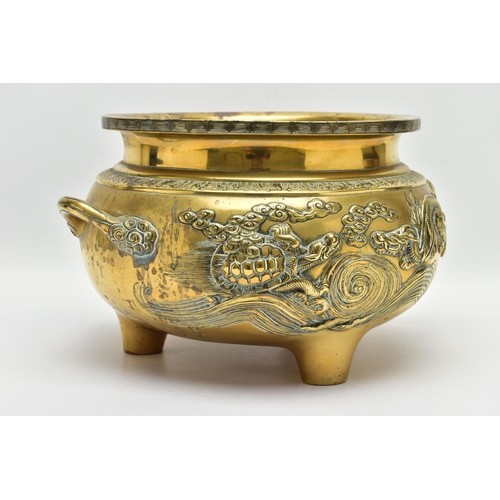 277 - A CHINESE BRASS TWIN HANDLED TRIPOD CENSER OF CIRCULAR FORM, cast in relief with four dragons, the i... 