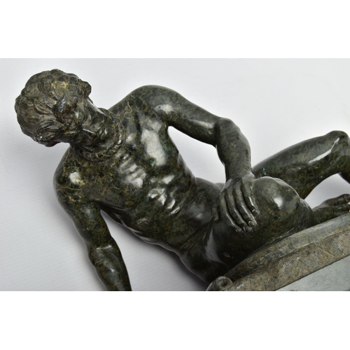 278 - A 19TH CENTURY CARVED SERPENTINE FIGURE OF THE DYING GAUL, AFTER THE ANTIQUE, on an integral oval pl... 