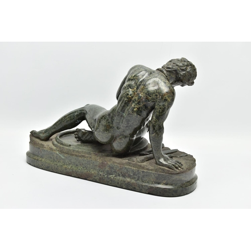 278 - A 19TH CENTURY CARVED SERPENTINE FIGURE OF THE DYING GAUL, AFTER THE ANTIQUE, on an integral oval pl... 