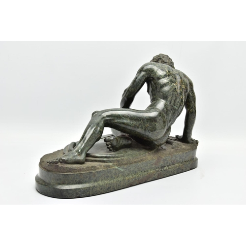 278 - A 19TH CENTURY CARVED SERPENTINE FIGURE OF THE DYING GAUL, AFTER THE ANTIQUE, on an integral oval pl... 