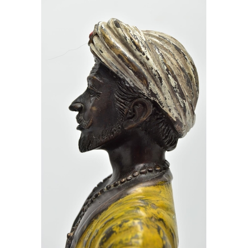 280 - A 2OTH CENTURY COLD PAINTED AND PATINATED BRONZE CANDLE HOLDER IN THE FORM OF A MIDDLE EASTERN MAN, ... 