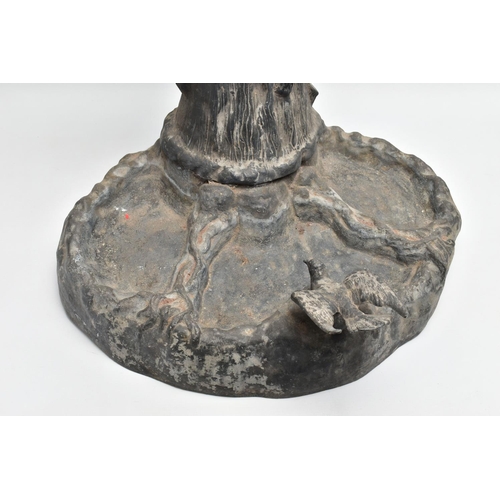 315 - AN EARLY 20TH CENTURY HOLLOW CAST LEAD FIGURAL BIRD BATH, modelled as a boy standing on a tree trunk... 