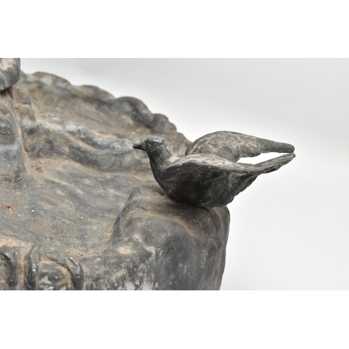 315 - AN EARLY 20TH CENTURY HOLLOW CAST LEAD FIGURAL BIRD BATH, modelled as a boy standing on a tree trunk... 