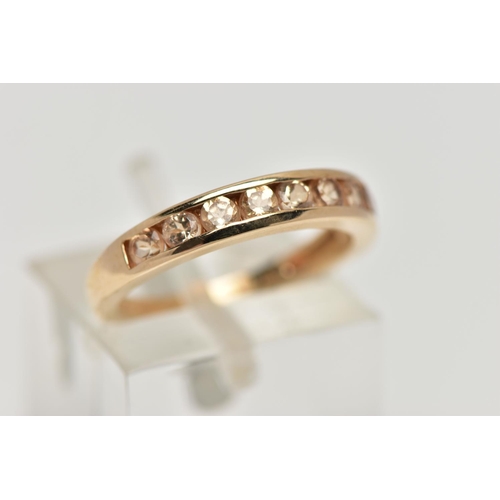 106 - A 9CT GOLD GEM SET HALF ETERNITY RING, the circular shape peachy colour gems assessed as tourmaline,... 
