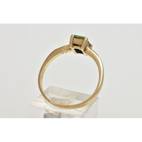 12 - A 9CT GOLD PERIDOT AND DIAMOND DRESS RING, the rectangular shape peridot, within a claw setting, to ... 