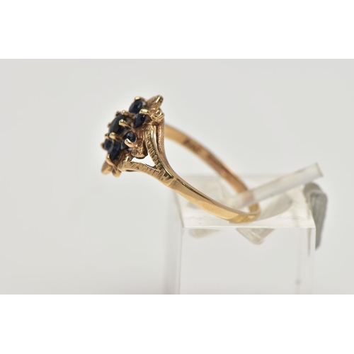 17 - A 9CT GOLD SAPPHIRE CLUSTER RING, designed as a floral cluster set with seven circular cut sapphires... 