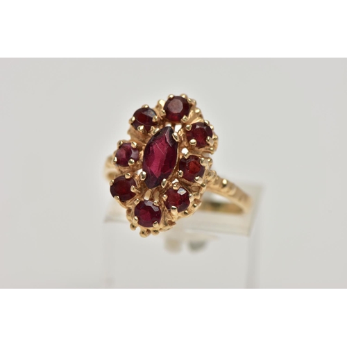 21 - A 9CT GOLD GARNET CLUSTER RING, the central marquise cut garnet surrounded by eight circular cut gar... 