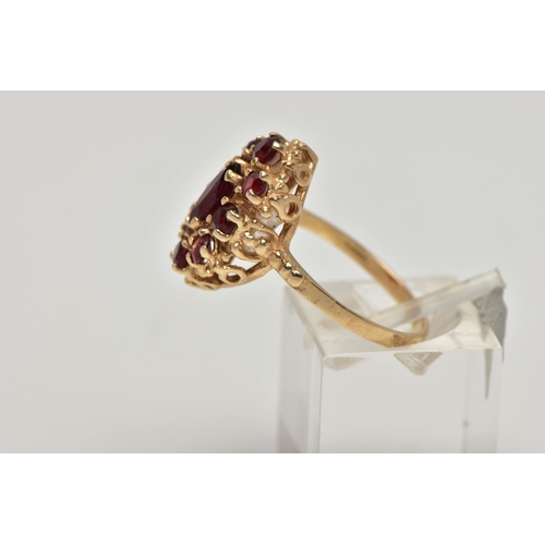 21 - A 9CT GOLD GARNET CLUSTER RING, the central marquise cut garnet surrounded by eight circular cut gar... 
