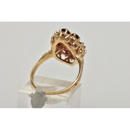 21 - A 9CT GOLD GARNET CLUSTER RING, the central marquise cut garnet surrounded by eight circular cut gar... 