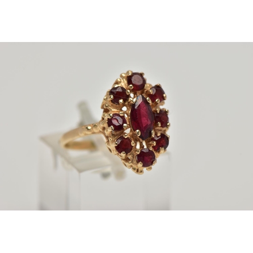 21 - A 9CT GOLD GARNET CLUSTER RING, the central marquise cut garnet surrounded by eight circular cut gar... 
