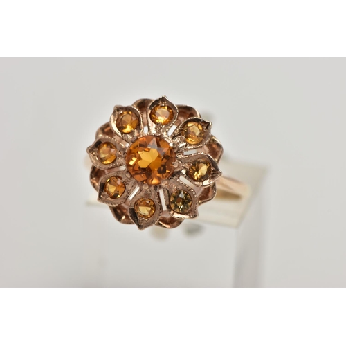 23 - A 9CT GOLD CITRINE CLUSTER RING, flower cluster set with circular cut citrines, approximate cluster ... 