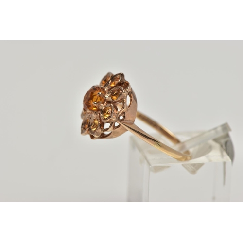 23 - A 9CT GOLD CITRINE CLUSTER RING, flower cluster set with circular cut citrines, approximate cluster ... 