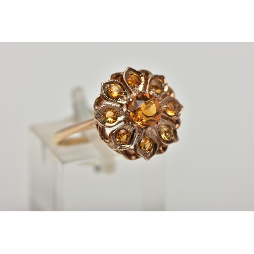 23 - A 9CT GOLD CITRINE CLUSTER RING, flower cluster set with circular cut citrines, approximate cluster ... 