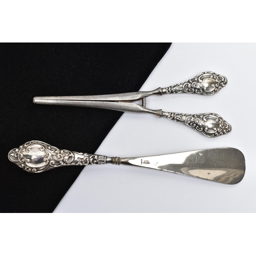 34 - A SILVER HANDLED SHOEHORN AND GLOVE STRETCHERS, a matching set detailing a scrolling foliage design,... 
