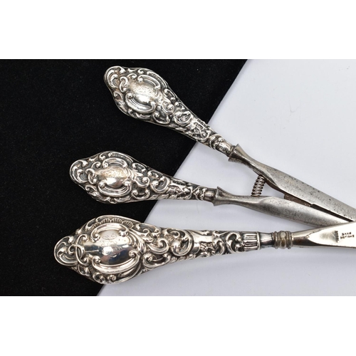 34 - A SILVER HANDLED SHOEHORN AND GLOVE STRETCHERS, a matching set detailing a scrolling foliage design,... 