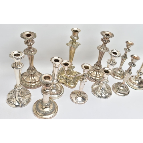 56 - A BOX OF ASSORTED WHITE METAL CANDLE STICKS, eleven candle sticks of various styles, all with weight... 