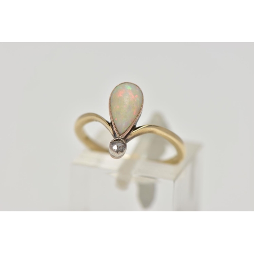 74 - A YELLOW METAL OPAL AND DIAMOND RING, milgrain collet mounted pear shape opal cabochon and a single ... 