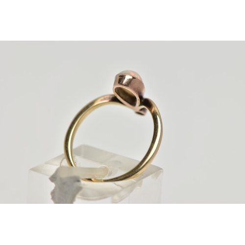 74 - A YELLOW METAL OPAL AND DIAMOND RING, milgrain collet mounted pear shape opal cabochon and a single ... 