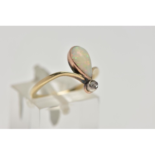 74 - A YELLOW METAL OPAL AND DIAMOND RING, milgrain collet mounted pear shape opal cabochon and a single ... 