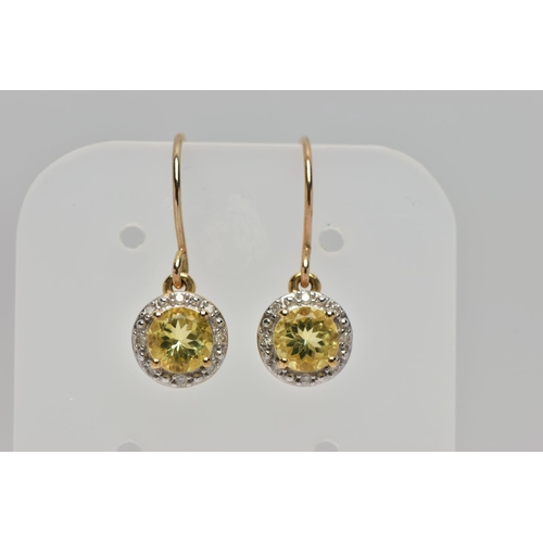 80 - A PAIR OF YELLOW METAL GEM SET EARRINGS, each designed with a circular drop set centrally with a cir... 