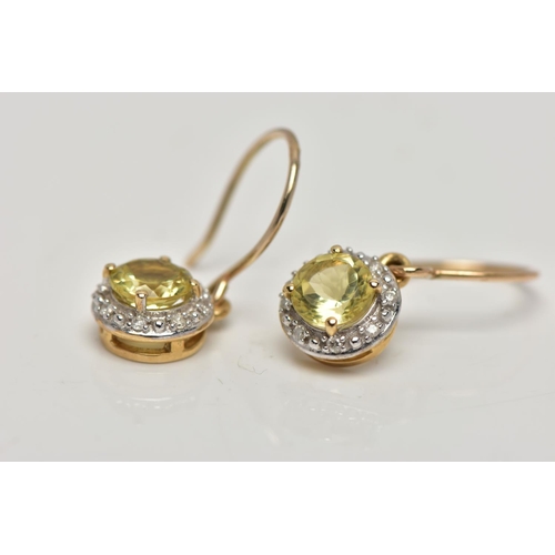80 - A PAIR OF YELLOW METAL GEM SET EARRINGS, each designed with a circular drop set centrally with a cir... 