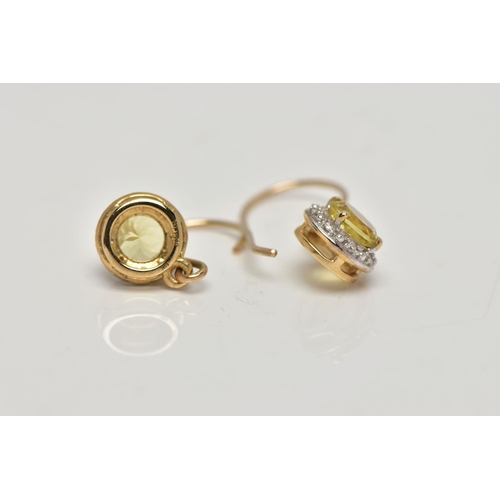 80 - A PAIR OF YELLOW METAL GEM SET EARRINGS, each designed with a circular drop set centrally with a cir... 