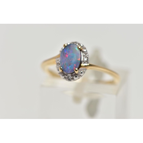 82 - A 9CT GOLD OPAL DOUBLET RING, oval opal cabochon doublet, four claw set in yellow gold, within a sin... 
