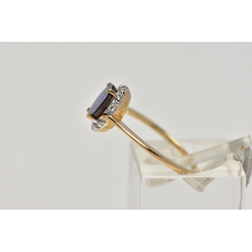 82 - A 9CT GOLD OPAL DOUBLET RING, oval opal cabochon doublet, four claw set in yellow gold, within a sin... 