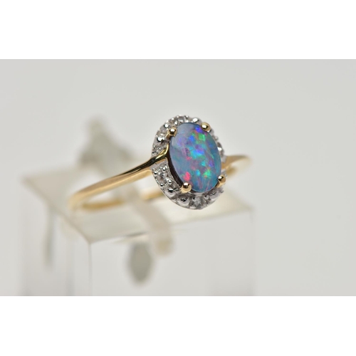82 - A 9CT GOLD OPAL DOUBLET RING, oval opal cabochon doublet, four claw set in yellow gold, within a sin... 