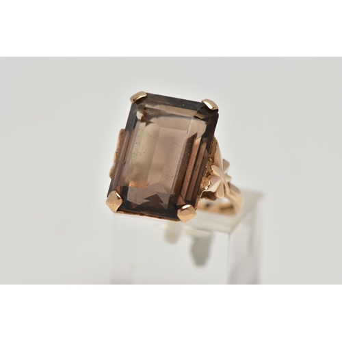 86 - A 9CT GOLD SMOKEY QUARTZ DRESS RING, a four claw set large rectangular cut smokey quartz, openwork g... 
