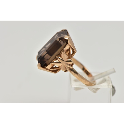 86 - A 9CT GOLD SMOKEY QUARTZ DRESS RING, a four claw set large rectangular cut smokey quartz, openwork g... 