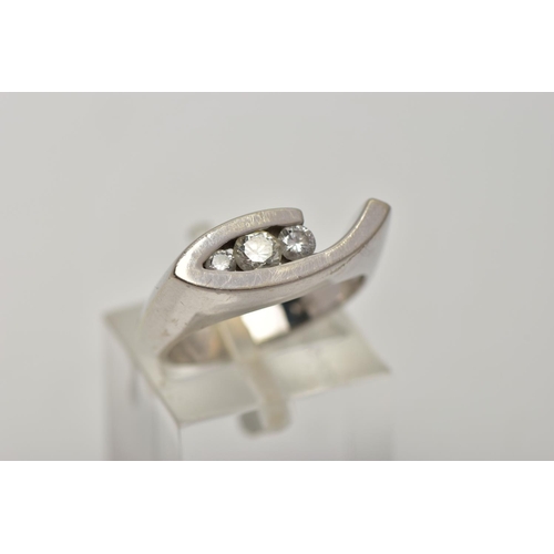 89 - A WHITE METAL DIAMOND RING, the ring head of an abstract lozenge shape, set with three graduated rou... 