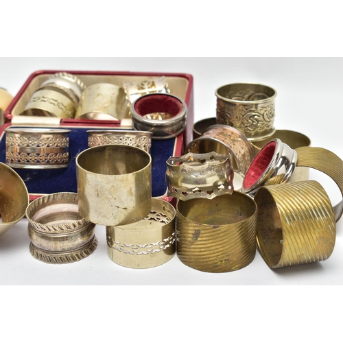 106 - AN ASSORTMENT OF WHITE METAL NAPKIN RINGS, to include a pair of cased napkin rings pierced circular ... 