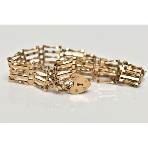 11 - A 9CT GOLD GATE BRACELET, five bar gate bracelet, hallmarked 9ct Dublin, fitted with a heart padlock... 