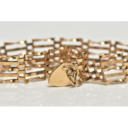 11 - A 9CT GOLD GATE BRACELET, five bar gate bracelet, hallmarked 9ct Dublin, fitted with a heart padlock... 