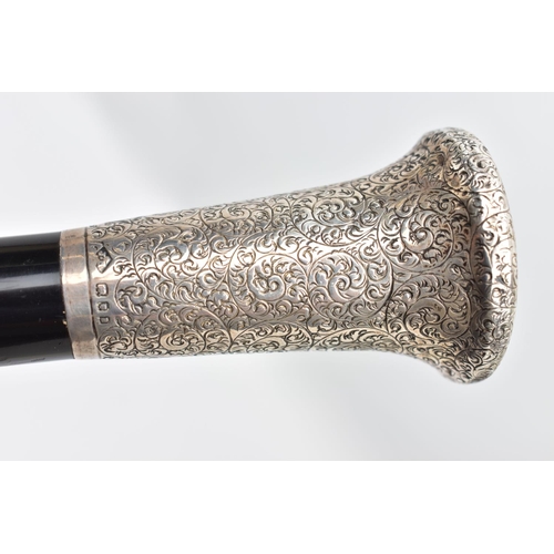 113 - AN EARLY 20TH CENTURY SILVER MOUNTED WALKING STICK, a silver pommel intricately detailed with a scro... 