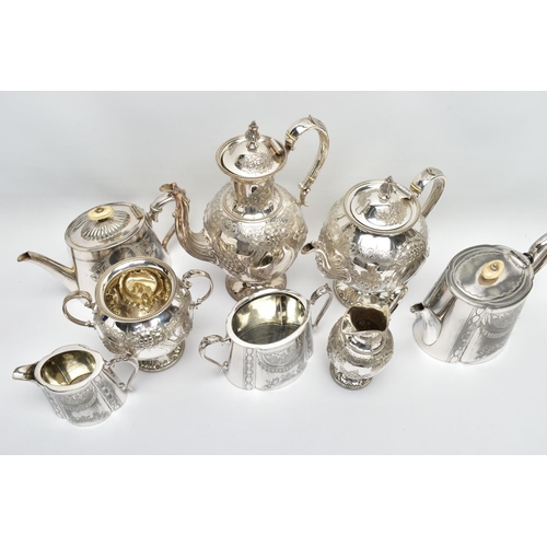 124 - TWO WHITE METAL TEA SETS, the first comprising of a coffee pot, a tea pot, milk jug and sugar bowl, ... 