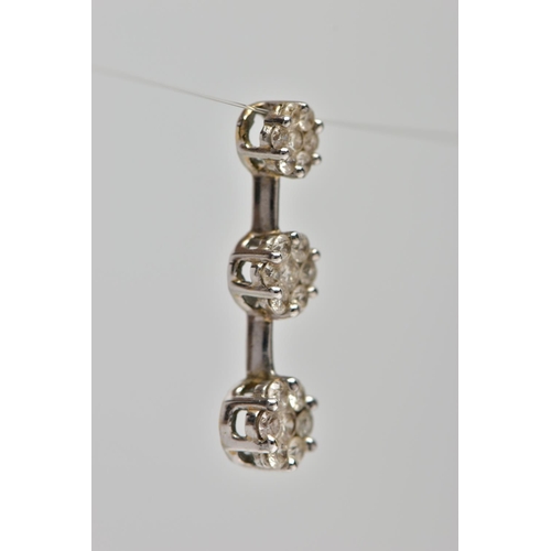 2 - A 9CT WHITE GOLD DIAMOND CLUSTER PENDANT, comprising of three graduated brilliant cut diamond floral... 