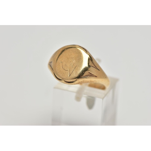 22 - A 9CT GOLD SIGNET RING, oval signet with worn engraving, textured shoulders leading onto a tapering ... 