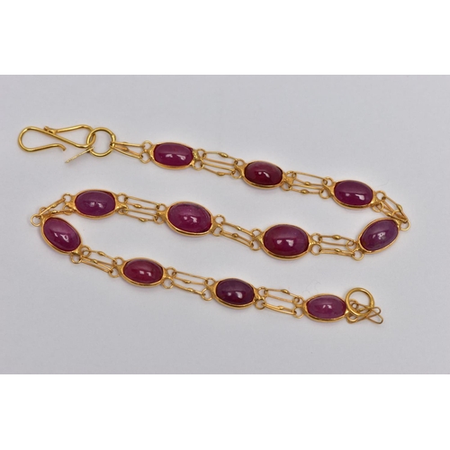 49 - A YELLOW METAL AND RUBY SPECTACLE SET BRACELET, comprised of eleven slightly graduated oval cabochon... 