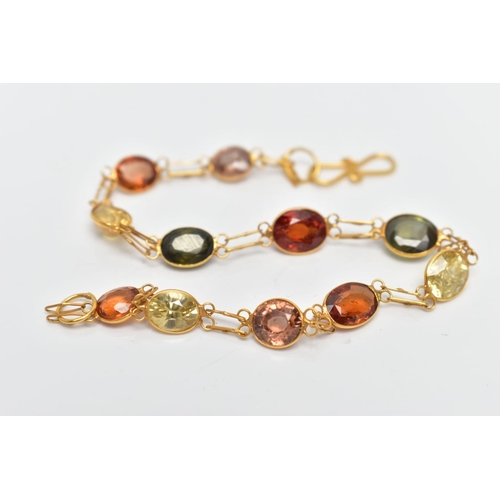 54 - A YELLOW METAL GARNET AND ZIRCON SPECTACLE SET BRACELET, comprised of eleven mixed cut garnets and z... 