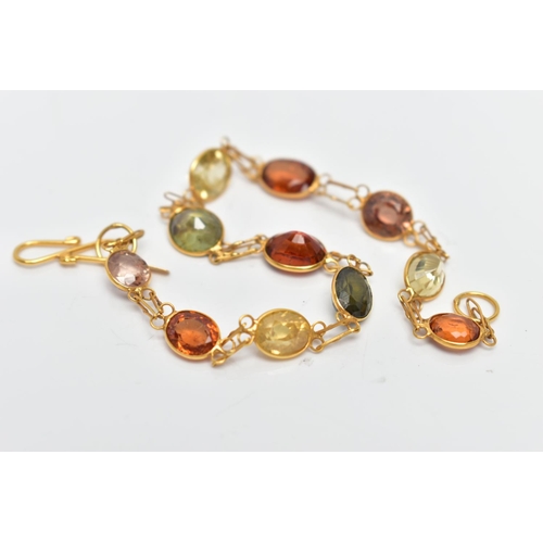 54 - A YELLOW METAL GARNET AND ZIRCON SPECTACLE SET BRACELET, comprised of eleven mixed cut garnets and z... 