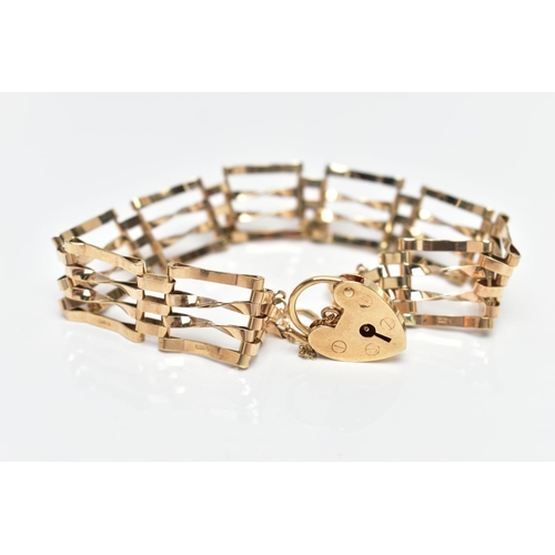 76 - A 9CT GOLD GATE BRACELET, four bar polished yellow gold gate bracelet, fitted with a heart padlock a... 