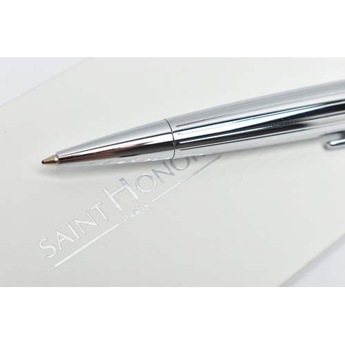 83 - A SAINT HONORE BALLPOINT PEN, a white metal twist weighted pen, detailed with a linear grooved patte... 