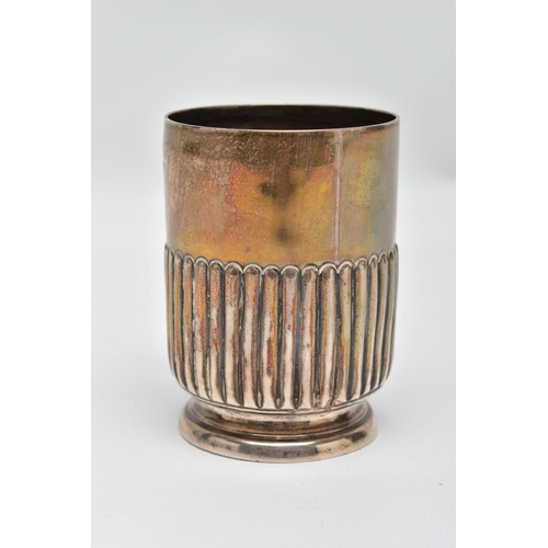 93 - A SILVER MUG, stop reeded pattern, raised on a round base, fitted with a curved handle, worn gilt, h... 