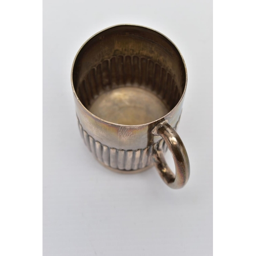 93 - A SILVER MUG, stop reeded pattern, raised on a round base, fitted with a curved handle, worn gilt, h... 