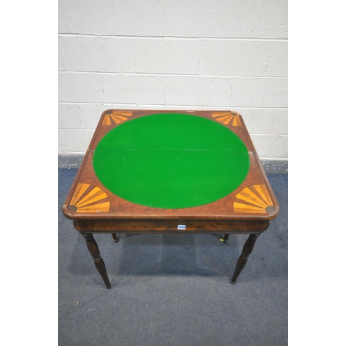 1583 - AN EARLY 20TH CENTURY WALNUT FOLD OVER GAMES TABLE, with circular green baize, on tuned legs. 86cm s... 