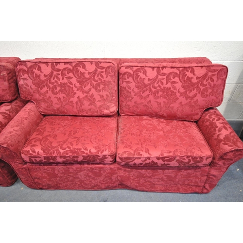 1593 - A BEIGE UPHOLSTERED TWO PIECE SUITE, comprising a two seater sofa and an armchair, both with red flo... 