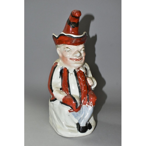 435 - A STAFFORDSHIRE TOBY JUG IN THE FORM OF MR PUNCH, with red, black and white striped outfit, the hat ... 